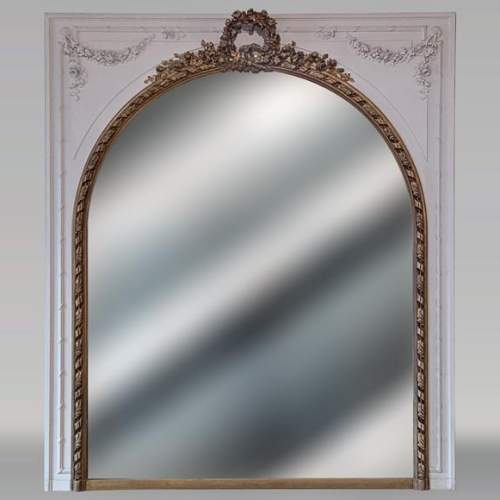 Trumeau de style Louis XVI peinture blanche et dorée aux couronnes de fleurs