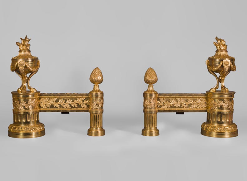 Paire de chenets anciens en bronze doré de style Louis XVI à décor de pots à feux tripodes-0