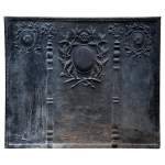 Importante plaque de cheminée ancienne aux Colonnes d'Hercule et branches de laurier de style Louis XVI