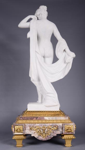 Pendule en marbre fleur de pêcher et bronze doré surmontée d’une sculpture en marbre   blanc statuaire représentant Phryné devant ses juges signée « Campagne », vers 1900-4