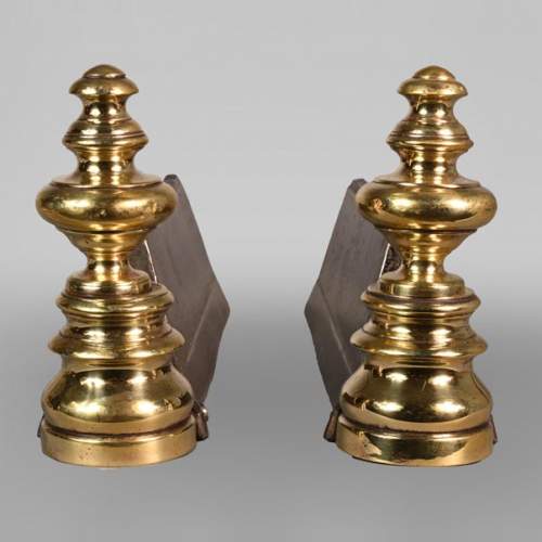 Paire de chenêts en fonte et bronze poli