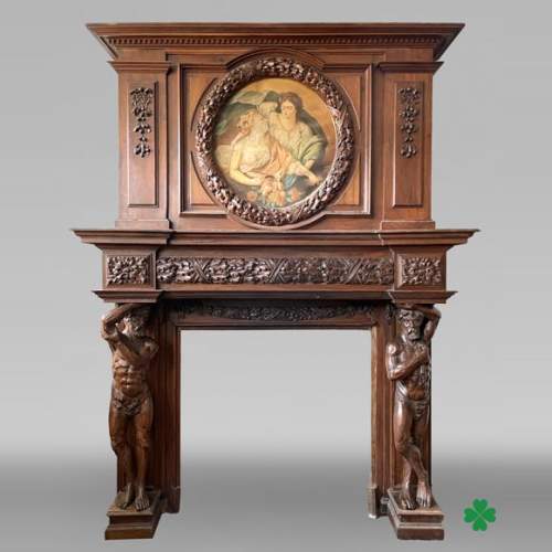 Grande cheminée monumentale en noyer sculpté, décorée d’atlantes et d’un médaillon peint